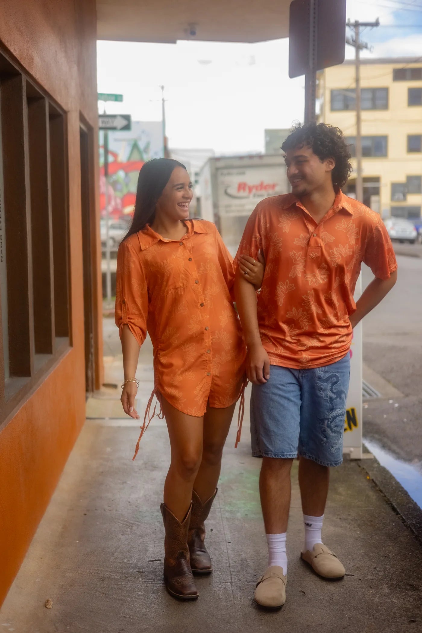 A couple in the Wehi Naupaka print on a Hawaiʻi Island street, the half-flower made whole