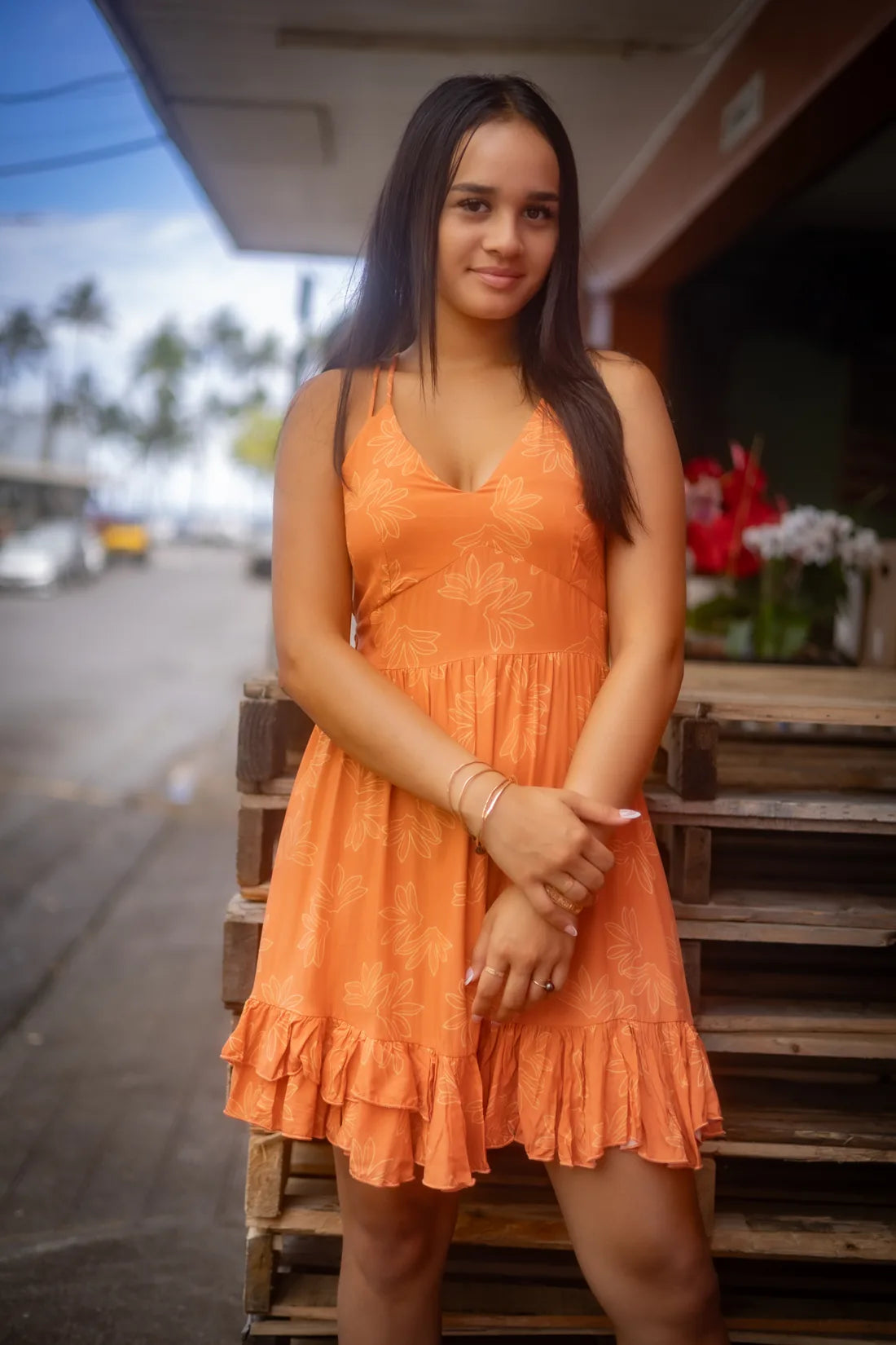 A wāhine in the warm coral Naupaka print on a Hawaiʻi Island street